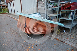 on thr garbage lies a discarded bathtub surrounded with copper pipes