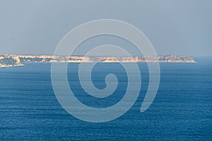 Thracian cliffs near blue clear water of Black Sea, wind farm