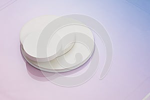 Three circular white risers on gradient pink to blue background. Mock up background for product placement photo