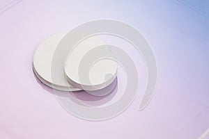 Three circular white risers on gradient pnk to blue background. Mock up background for product placement photo