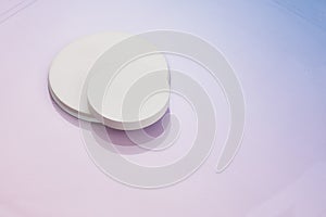 Three circular white risers on gradient pnk to blue background. Mock up background for product placement photo