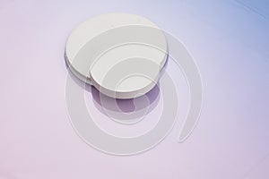 Thre circular white risers on gradient pnk to blue background. Mock up background for product placement photo