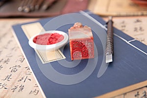 A thread-bound book with seals and ink pads placed on the book