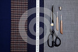 Thread fabric wool sewing man cage blue choice design atelier tailor many different things color tape-measure scissors