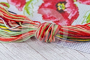 Thread floss in a frame with a knot for cross stitching