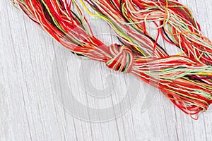 Thread floss in a frame with a knot for cross stitching