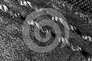 Thread seam on black leather material as background