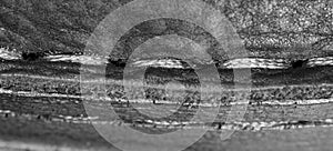 Thread seam on black leather material as background