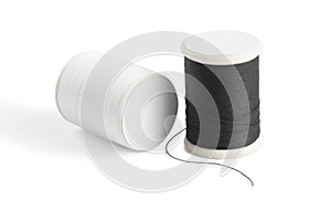 Thread spool on a white background. Basic color of thread: White, Black.