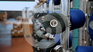 thread spools. close-up. racks with many thread spools. the process of preparing threads for dyeing, for the further