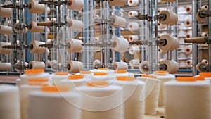 thread spools. close-up. racks with many thread spools. the process of preparing threads for dyeing, for the further