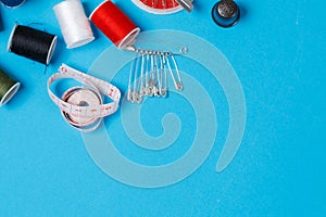 Thread Spools Tailor Equipment On Blue Background
