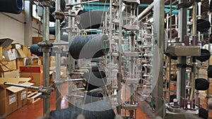 thread spools. textile industry. weaving factory. racks with many thread spools. dyeing and drying of threads for