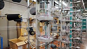 thread spools. textile industry. weaving factory. racks with many thread spools. dyeing and drying of threads for