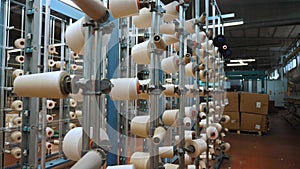 thread spools. textile industry. weaving factory. racks with many thread spools. dyeing and drying of threads for
