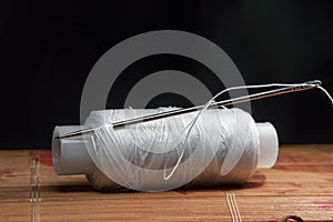 The thread is threaded through the eye of a sewing needle.Sewing and needlework classes.Workshop of hand craft and handmade.