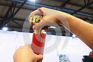 Threaded clamp fitting. A man screws a fitting into a plastic pipe. Used for heating systems, hot and cold water supply