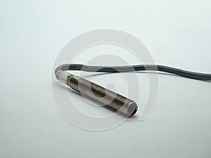 Threaded  inductive proximity sensor with cable used in industrial automation