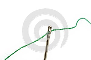 Threaded needle on white photo