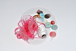 Threads, buttons and a spool of thread isolated on a white background.