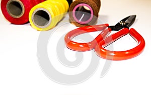Threads and scissors on a white background