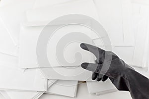 The threat in an envelope: People in protective impermeable gloves indicates an anonymous envelope to test for the presence of