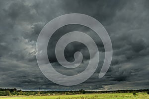 Threatening dark rain clouds over a vast plain.
