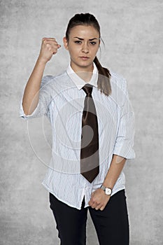 Threatening with a fist, businesswoman in a bad mood