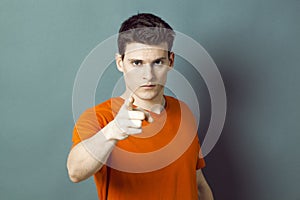 Threatening handsome man showing something with index photo