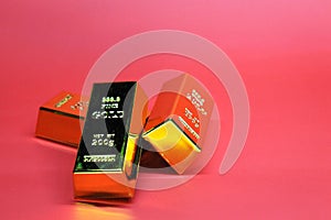 three 200 grams gold bars with a red background. Business Concept