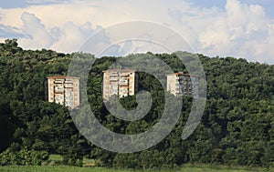 Three abusive houses on a hill in the woods