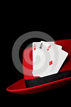 Three aces on felt hat, isolated on black