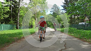 Three active boys riding bicycles