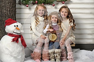 Three cute girls waiting for Christmas