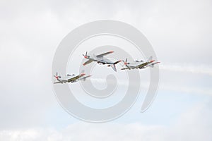 Three airplanes performing aerobatic figure
