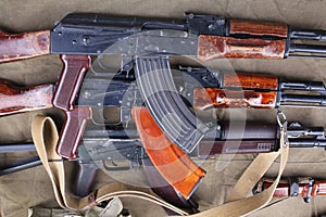 three ak 47 on canvas with ammunitions on canvas