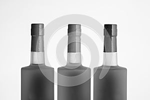 Three alcohol bottle tops in black and white