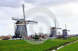 Three aligned windmills