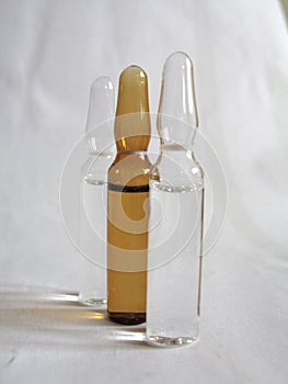 Three ampoules on a white background
