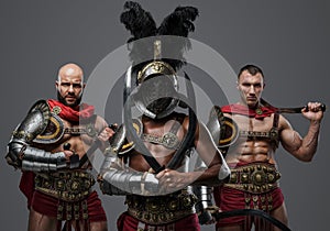Three ancient gladiators with plumed helmet and swords