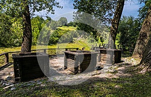 Three ancient wooden wells at the edge of the forest