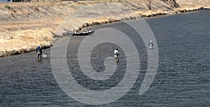 Three anglers wading in the Missouri River.