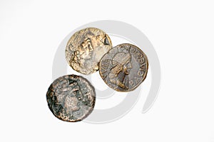 Three antique coins with portraits on a white background