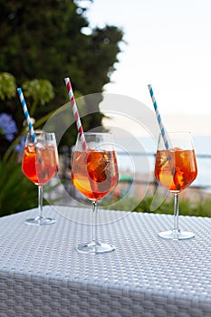 Three aperol spritz on a summer evening in a mediterranean pub