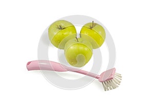 Three apples and brush for washing of fruit
