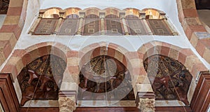 Three arches revealing three wooden domes decorated with floral patterns with interleaved wood window Mashrabiya, Beshtak palace photo