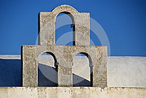 Three Arches Silhouetted Against Blue Sky