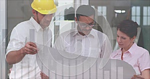 Three architects discuss with a building plan in office