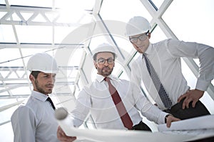 Three architects discussing sketches for a new project