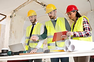 Three arhitects working together on construction site project